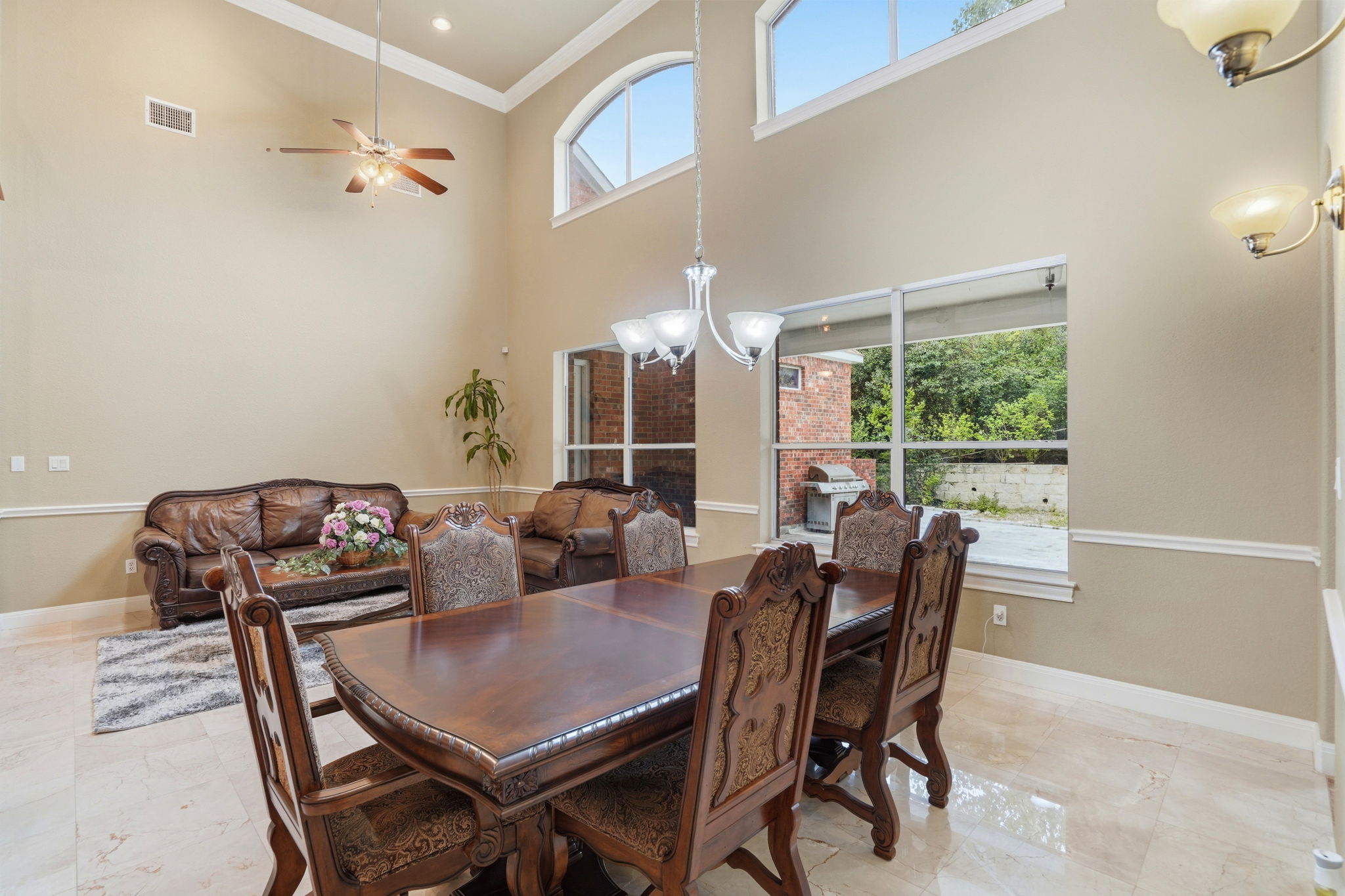 222 Vailco Lane Austin, TX 78738 - Photo 23 of 39 Spacious formal dining area featuring a high vaulted ceiling, decorative crown molding, and large windows with transom accents