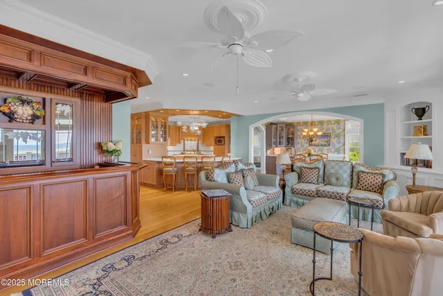 a view of a dining room with furniture a chandelier and wooden floor