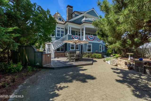 a living room with fireplace furniture and a view of kitchen