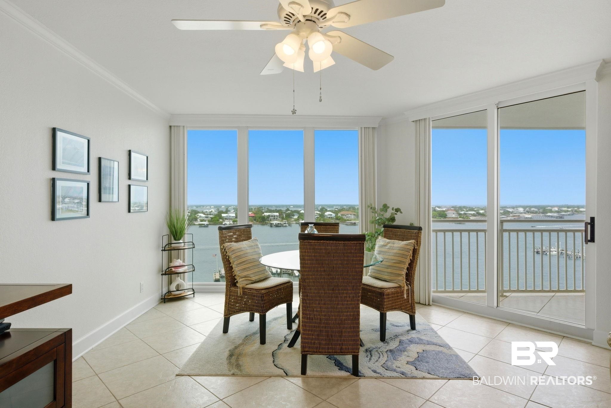 16284 Perdido Key Drive, Unit 912 Perdido Key, FL 32507 - Photo 17 of 49 Dining space with a ceiling fan, a water view, ornamental molding, and light tile patterned flooring