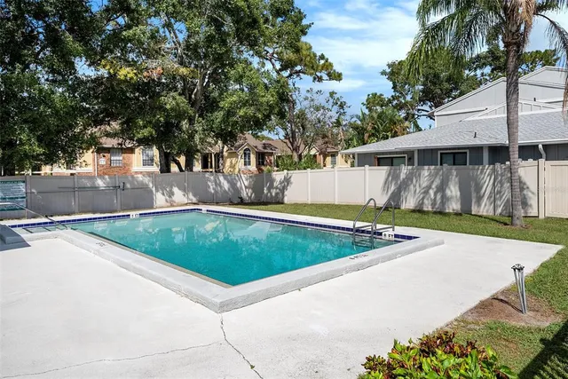 a view of a backyard with swimming pool
