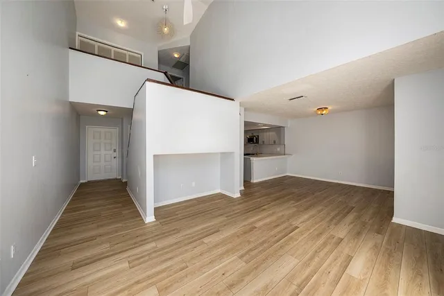 a view of empty room with wooden floor