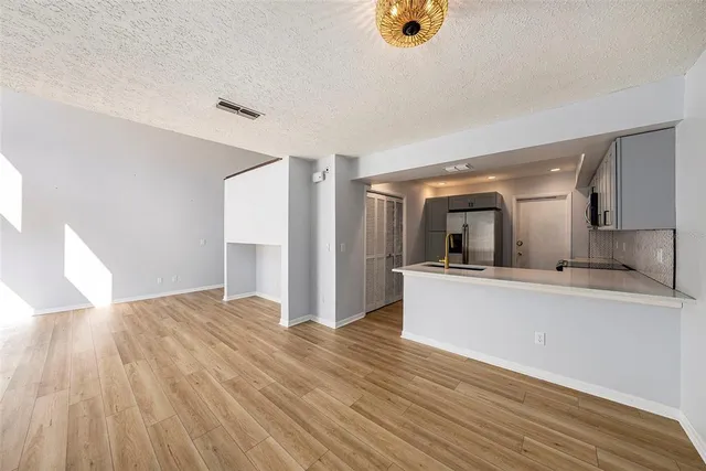 a view of kitchen and hall with wooden floor