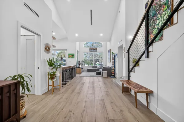 a living room with furniture and a wooden floor