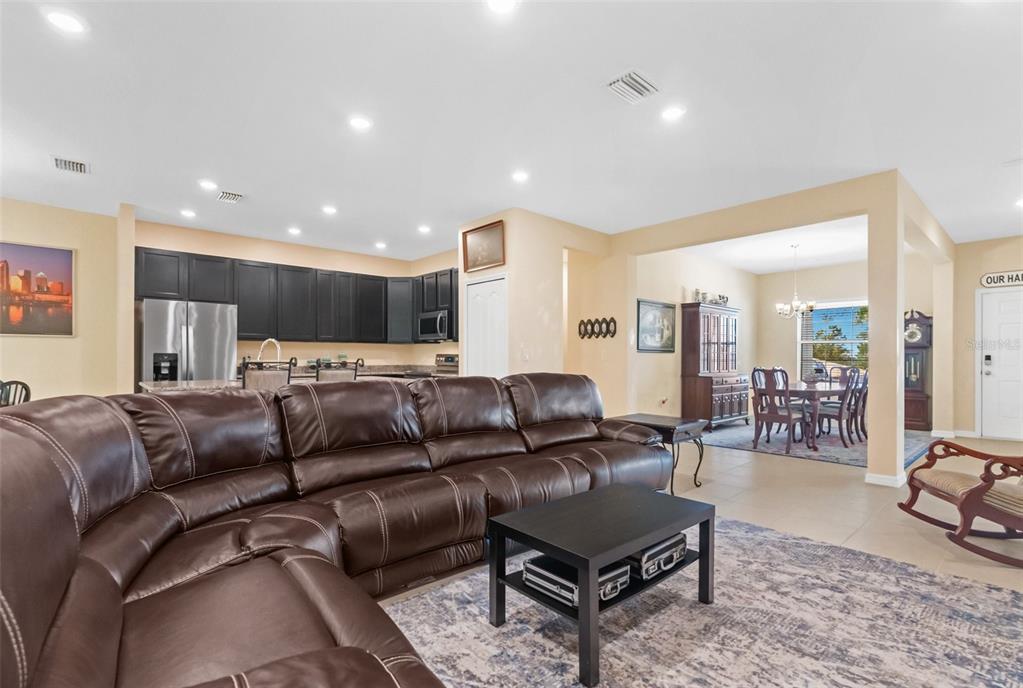 6283 Grapewood Road Spring Hill, FL 34609 - Photo 15 of 41 a living room with furniture and a dining table with wooden floor