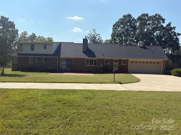 an empty room with wooden floor and fan