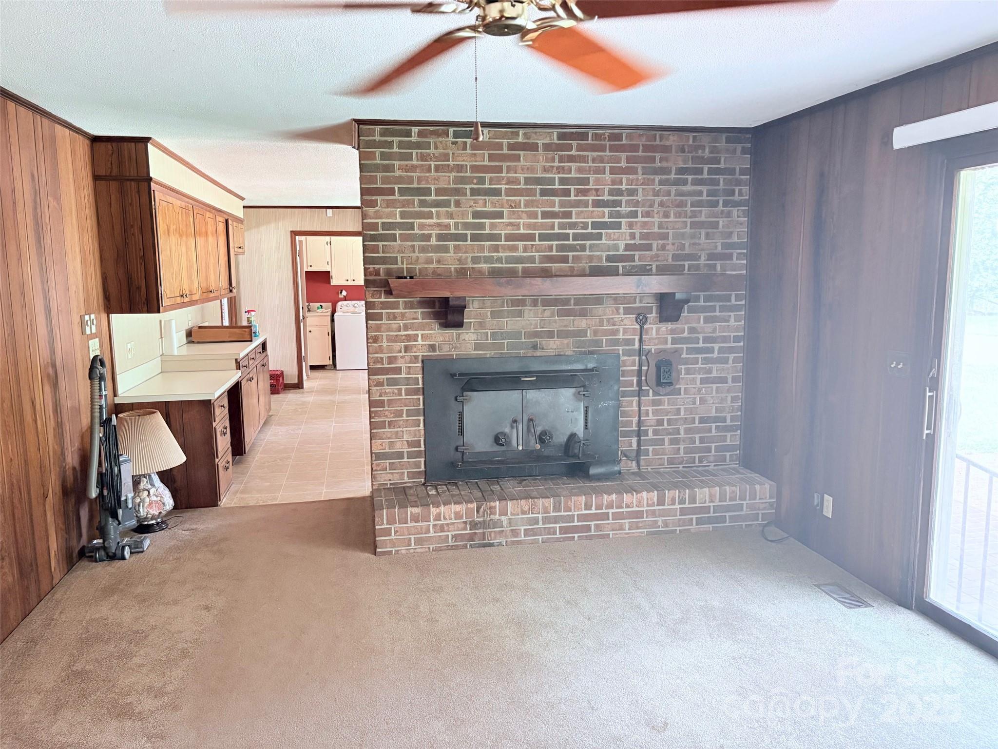 507 Poplar Springs Church Road Shelby, NC 28152 - Photo 22 of 47 an empty room with fireplace and window