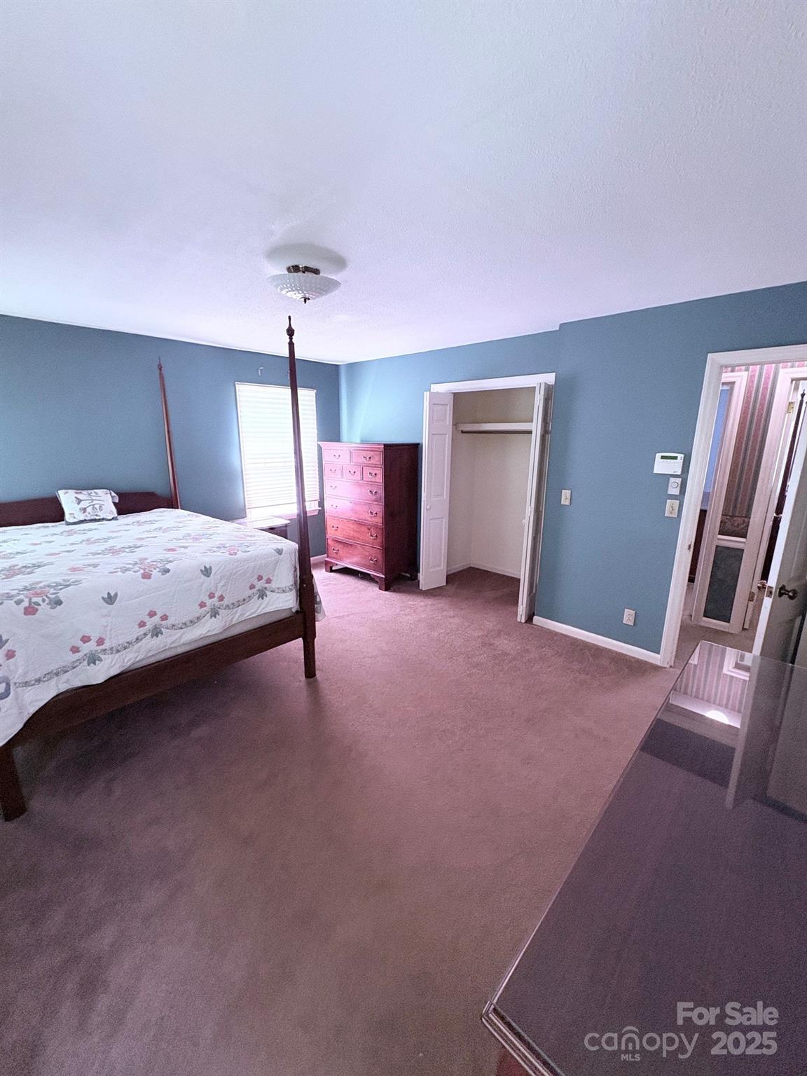 507 Poplar Springs Church Road Shelby, NC 28152 - Photo 24 of 47 a bedroom with a bed and a chandelier