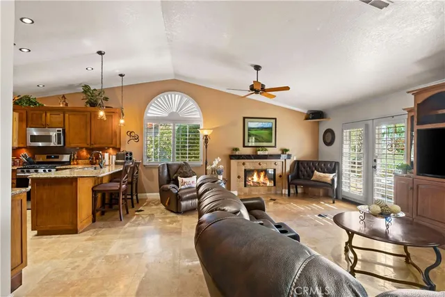 a kitchen with granite countertop a sink stove and cabinets
