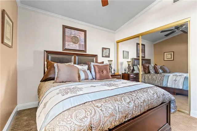 a view of a patio with table and chairs under an umbrella with a small yard