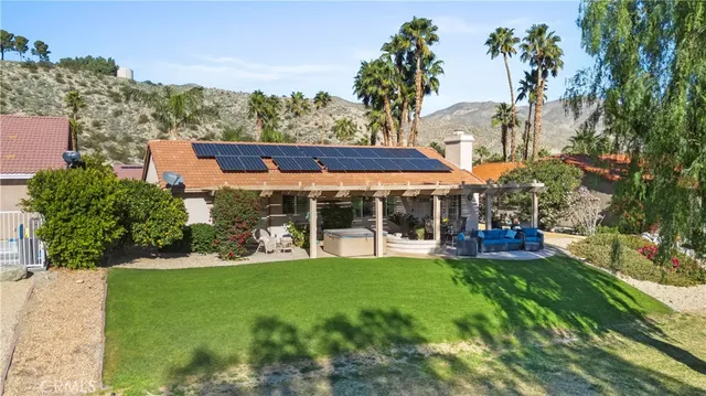 a view of a patio with a table chairs and backyard