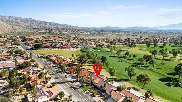 a living room with furniture a fireplace and a dining table with wooden floor