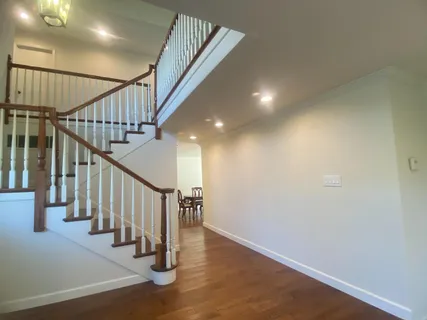 a view of an entryway with wooden floor