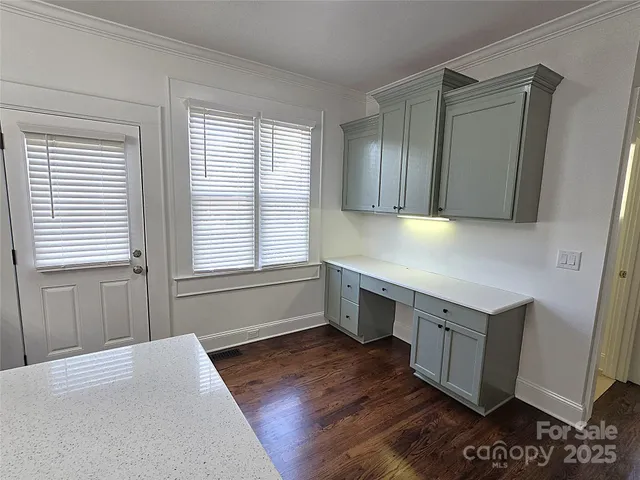 a kitchen with stainless steel appliances granite countertop a sink a stove a refrigerator a window and cabinets