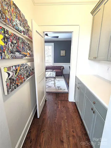 a view of a bathroom with a sink and wooden floor