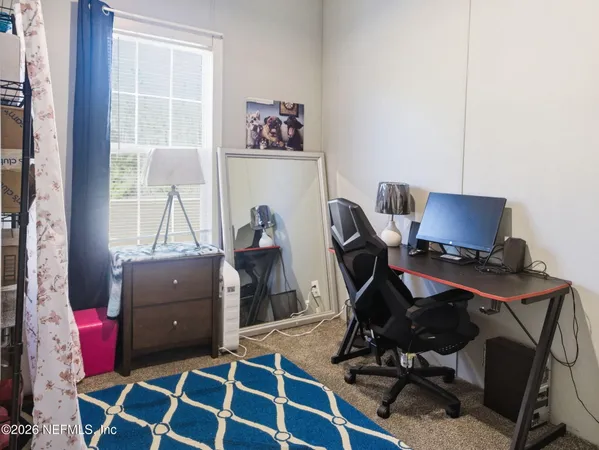 a view of a workspace with furniture and wooden floor