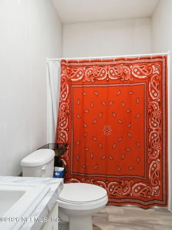 a view of a yard with wooden fence