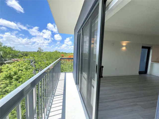 a view of balcony with wooden floor