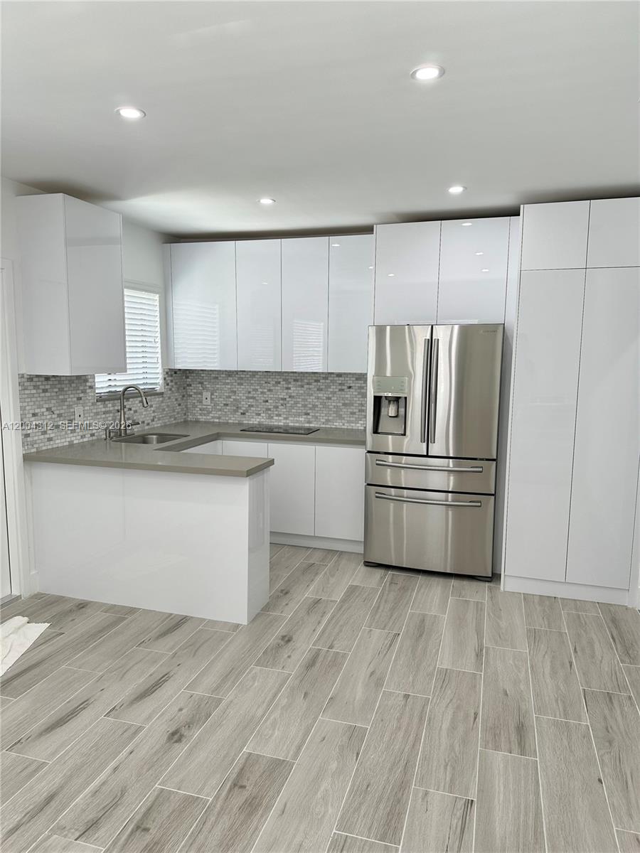 551 Southwest 57th Avenue, Unit 1 Miami, FL 33144 - Photo 1 of 24 a kitchen with stainless steel appliances granite countertop a refrigerator and a stove top oven