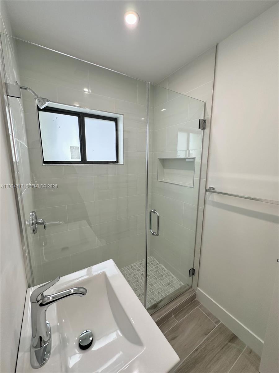 551 Southwest 57th Avenue, Unit 1 Miami, FL 33144 - Photo 12 of 24 a bathroom with a sink and a tub