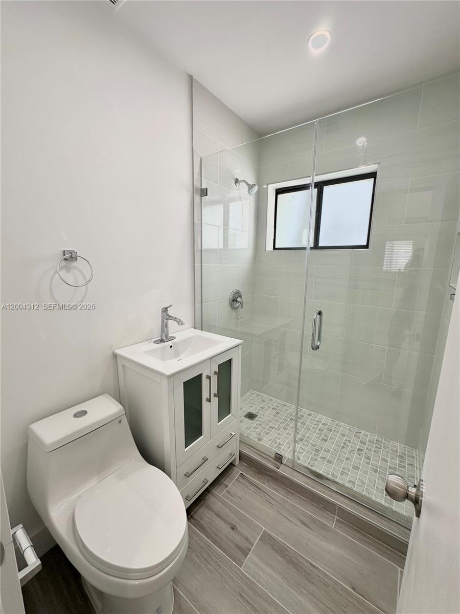551 Southwest 57th Avenue, Unit 1 Miami, FL 33144 - Photo 13 of 24 a white toilet sitting next to a bathroom sink