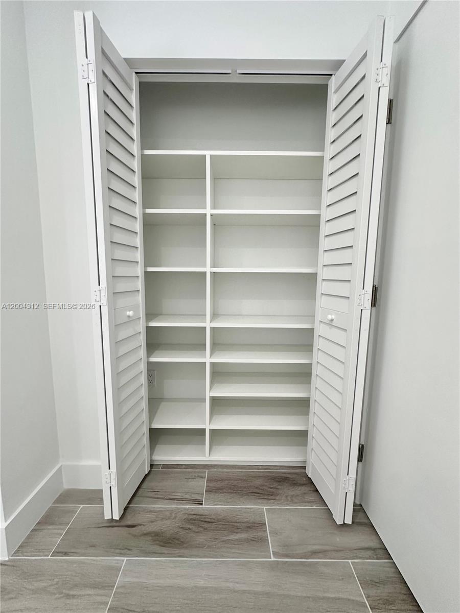551 Southwest 57th Avenue, Unit 1 Miami, FL 33144 - Photo 14 of 24 a view of walk in closet with empty racks