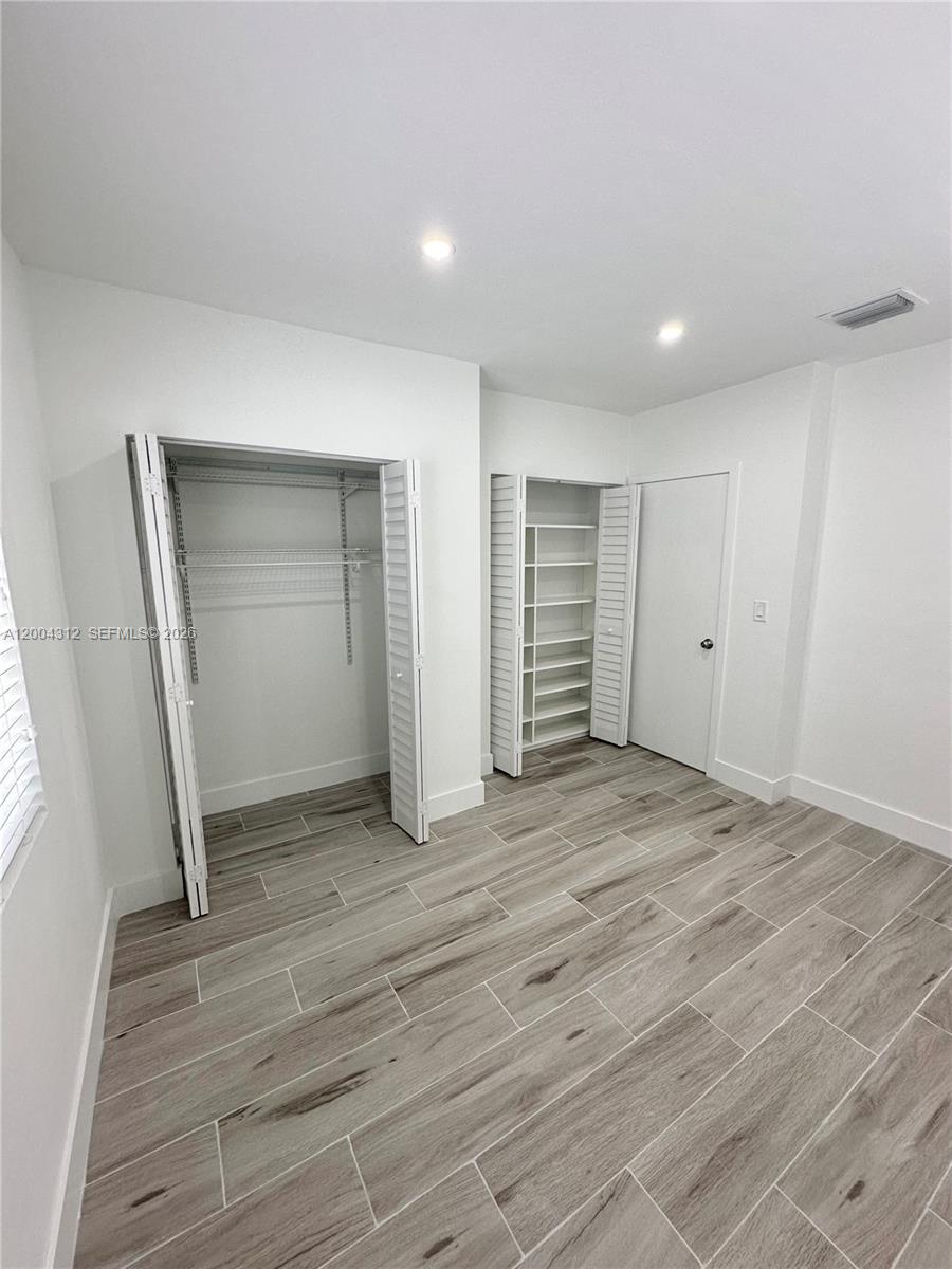 551 Southwest 57th Avenue, Unit 1 Miami, FL 33144 - Photo 16 of 24 a view of empty room with wooden floor