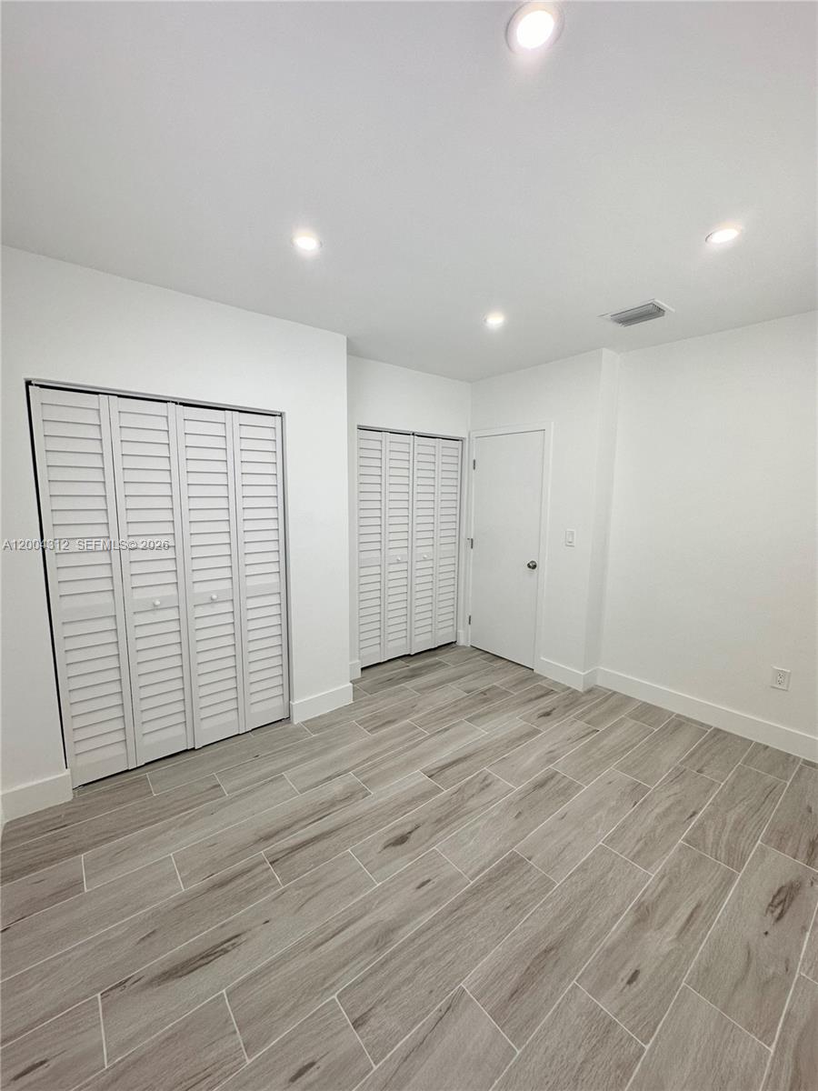 551 Southwest 57th Avenue, Unit 1 Miami, FL 33144 - Photo 20 of 24 a view of an empty room with wooden floor