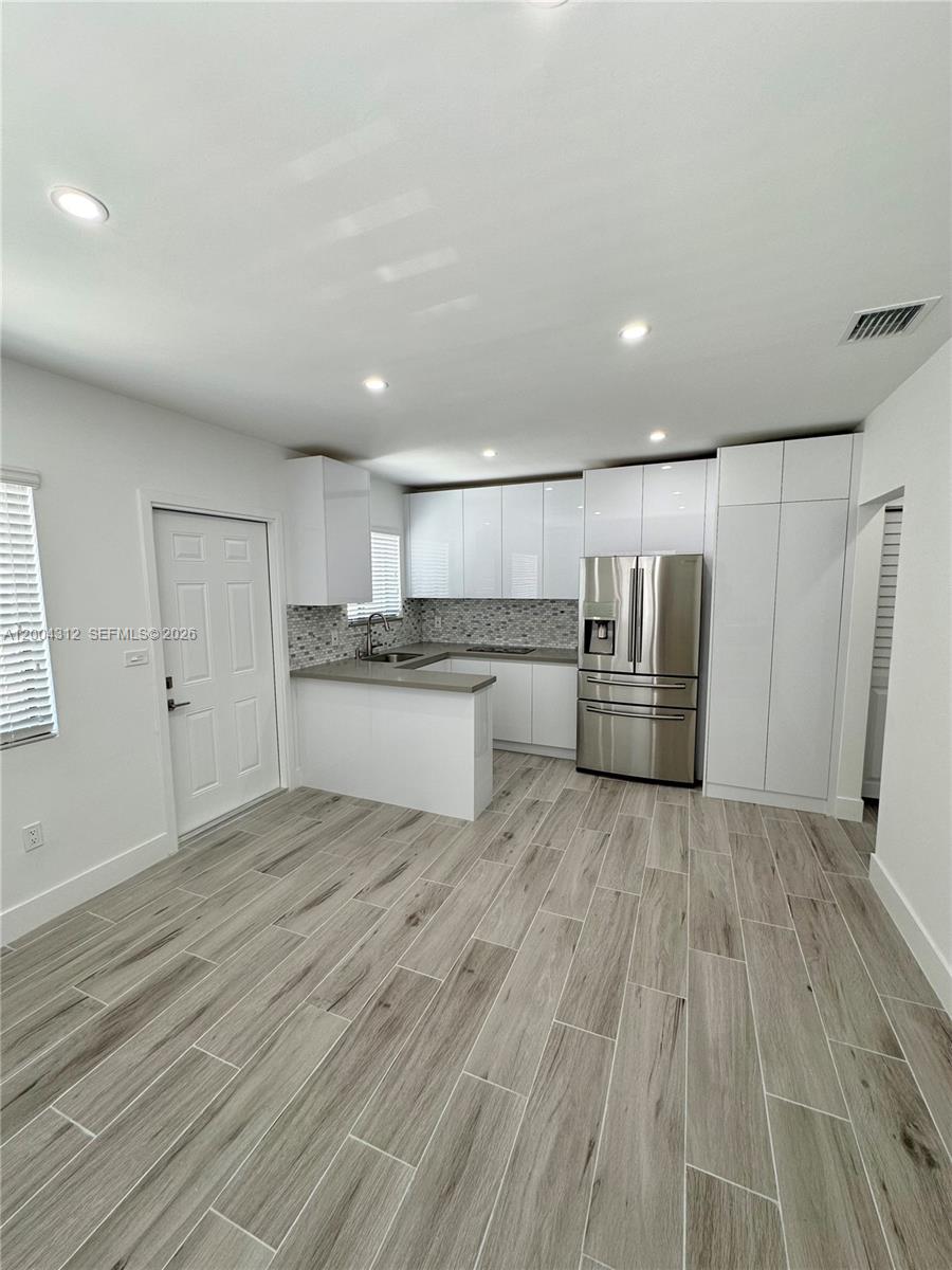 551 Southwest 57th Avenue, Unit 1 Miami, FL 33144 - Photo 2 of 24 a large kitchen with stainless steel appliances granite countertop a stove and a refrigerator