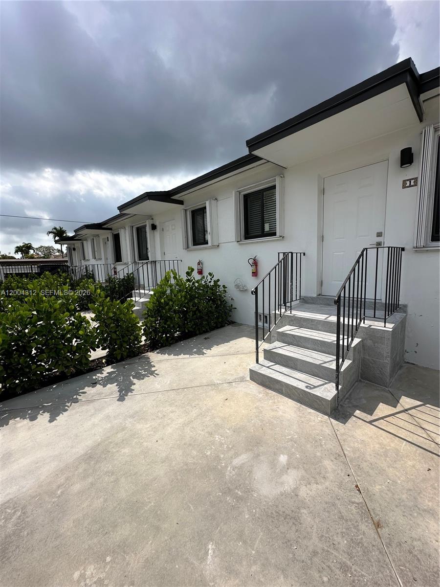 551 Southwest 57th Avenue, Unit 1 Miami, FL 33144 - Photo 24 of 24 a view of a house with wooden wall and a large window
