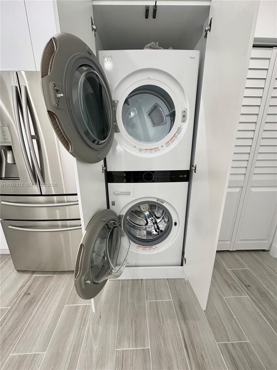 551 Southwest 57th Avenue, Unit 1 Miami, FL 33144 - Photo 7 of 24 a close view of utility and dryer on a shelf