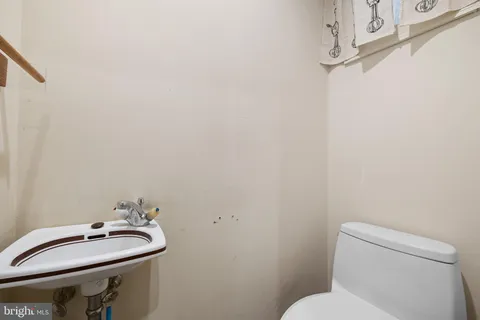 a bathroom with a sink mirror and toilet