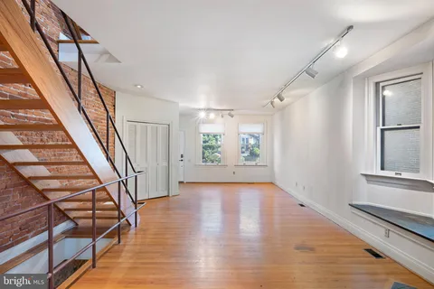 a view of an entryway with wooden floor and stairs