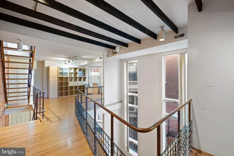a view of entryway and hall with wooden floor