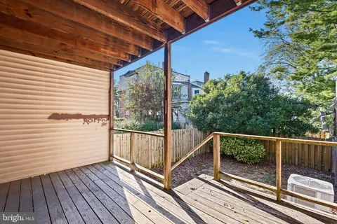 a view of balcony with wooden floor and fence