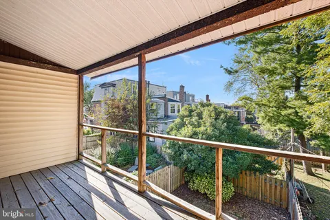 a view of a balcony with wooden floor