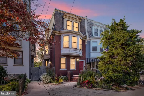 a view of a brick building next to a yard
