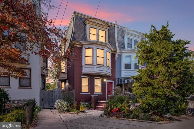 a view of a brick building next to a yard