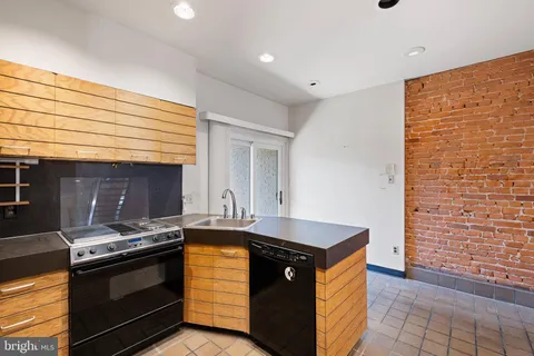 a kitchen with stainless steel appliances granite countertop a stove and a sink