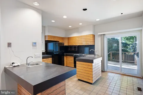 a kitchen with a sink a counter top space and stainless steel appliances