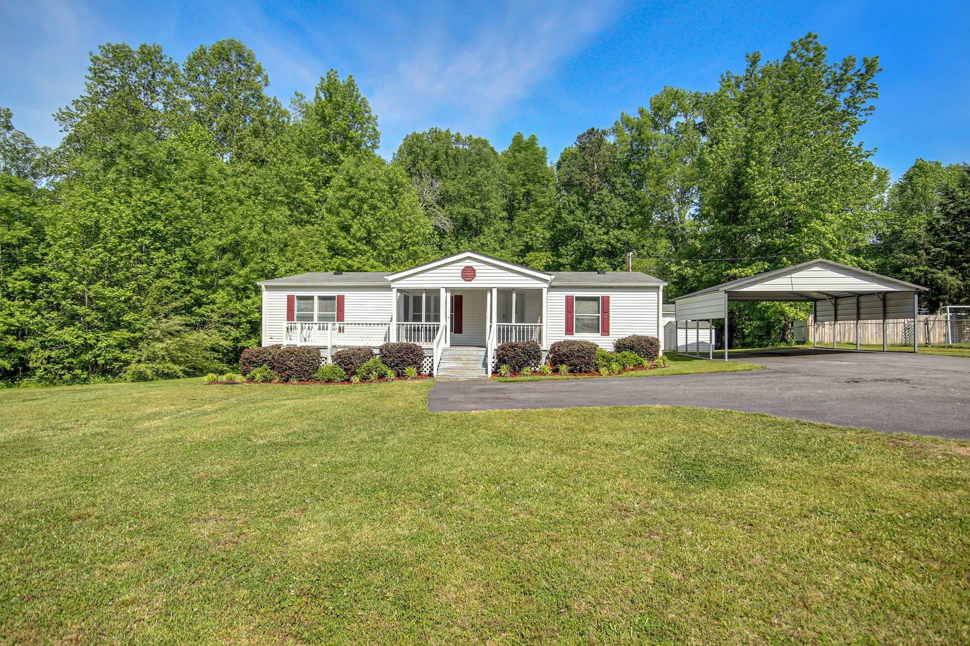 8144 Mt Pleasant Church Road Willow Spring, NC 27592 - Photo 1 of 25 a front view of a house with a garden