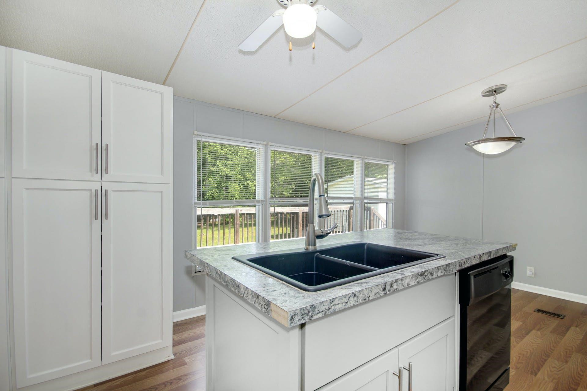 8144 Mt Pleasant Church Road Willow Spring, NC 27592 - Photo 12 of 25 a kitchen that has a sink and a stove
