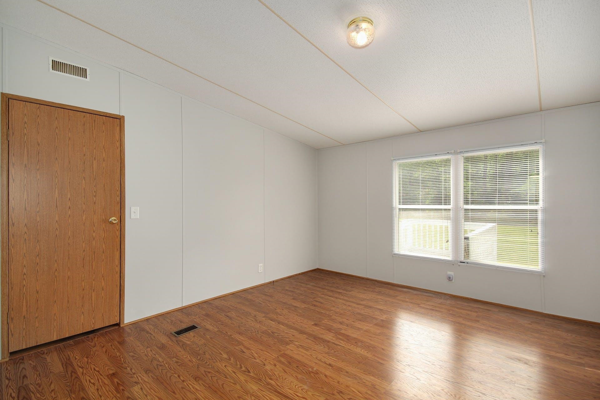 8144 Mt Pleasant Church Road Willow Spring, NC 27592 - Photo 14 of 25 an empty room with wooden floor and windows