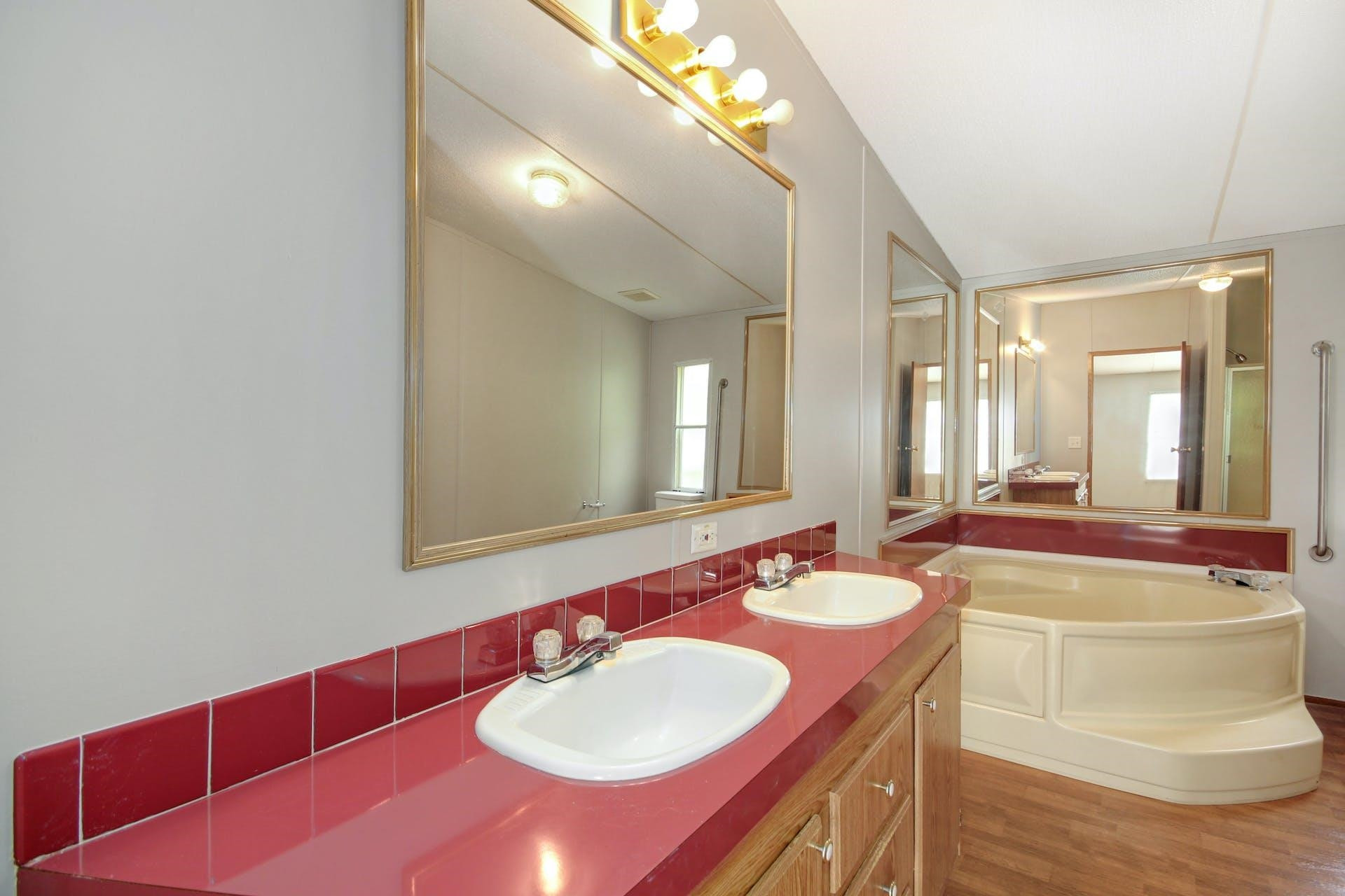 8144 Mt Pleasant Church Road Willow Spring, NC 27592 - Photo 16 of 25 a bathroom with a sink and a mirror