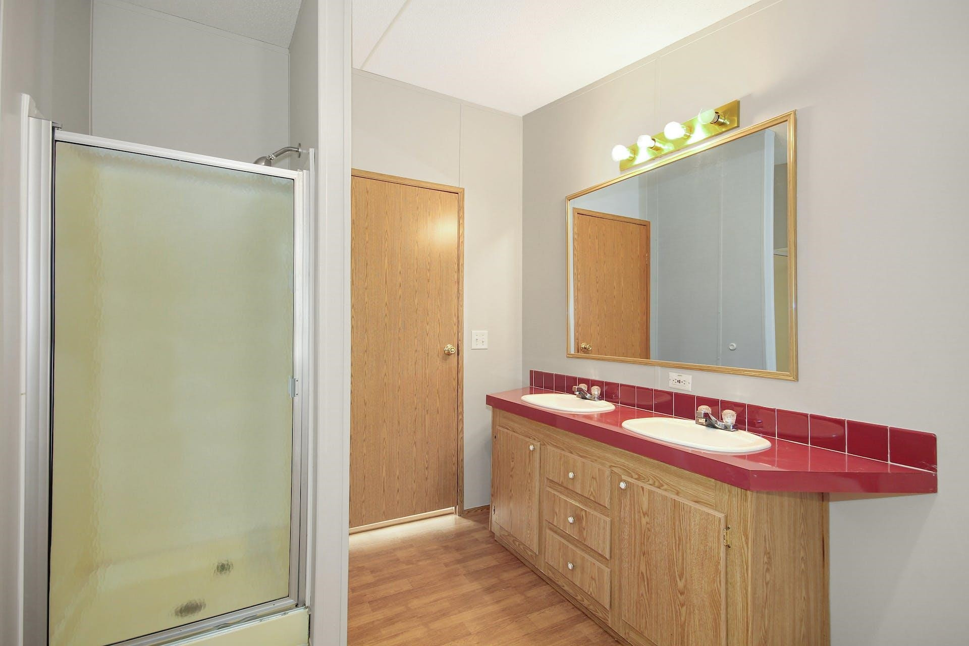 8144 Mt Pleasant Church Road Willow Spring, NC 27592 - Photo 17 of 25 a bathroom with a sink and a mirror