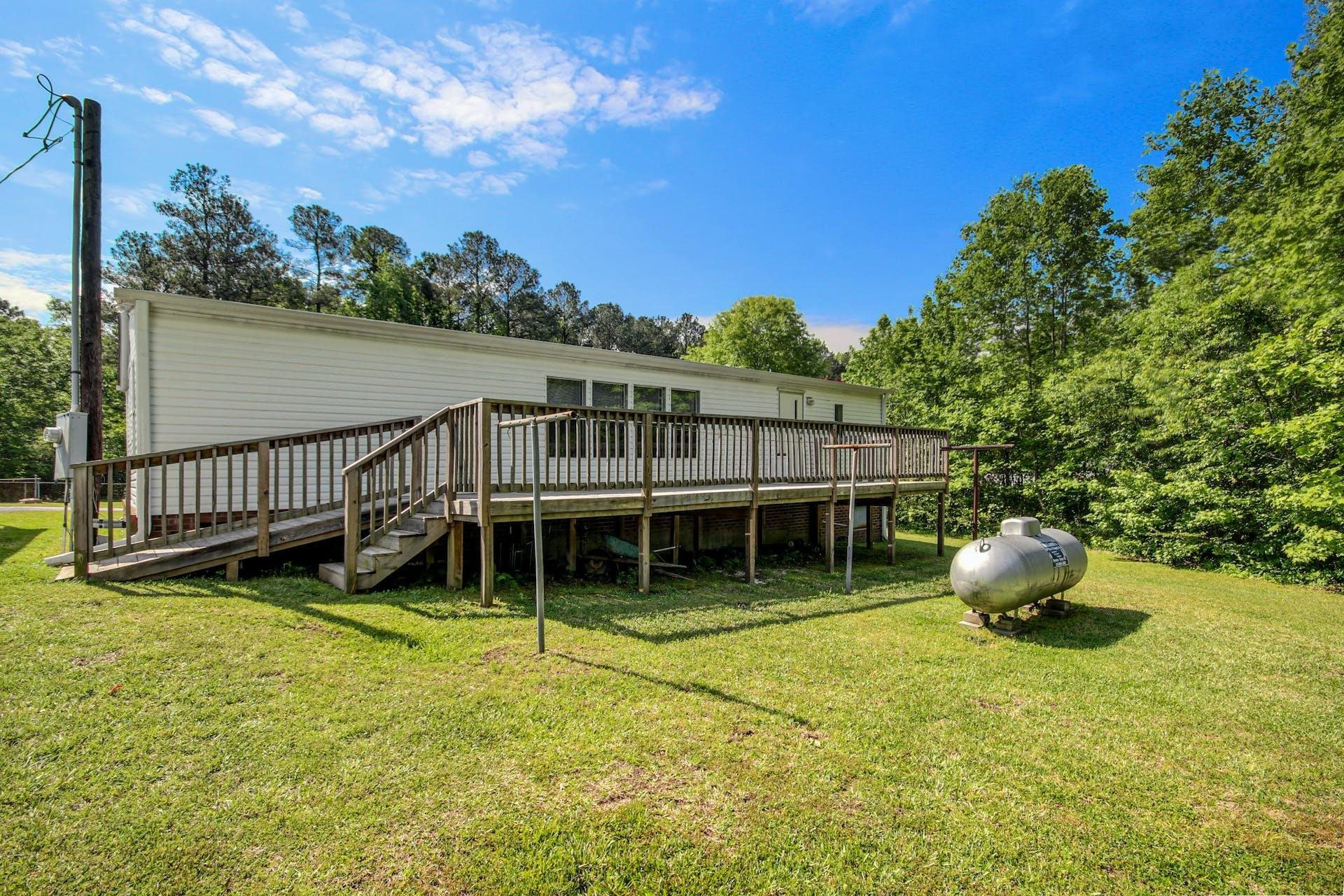 8144 Mt Pleasant Church Road Willow Spring, NC 27592 - Photo 20 of 25 a backyard of a house with yard and outdoor seating
