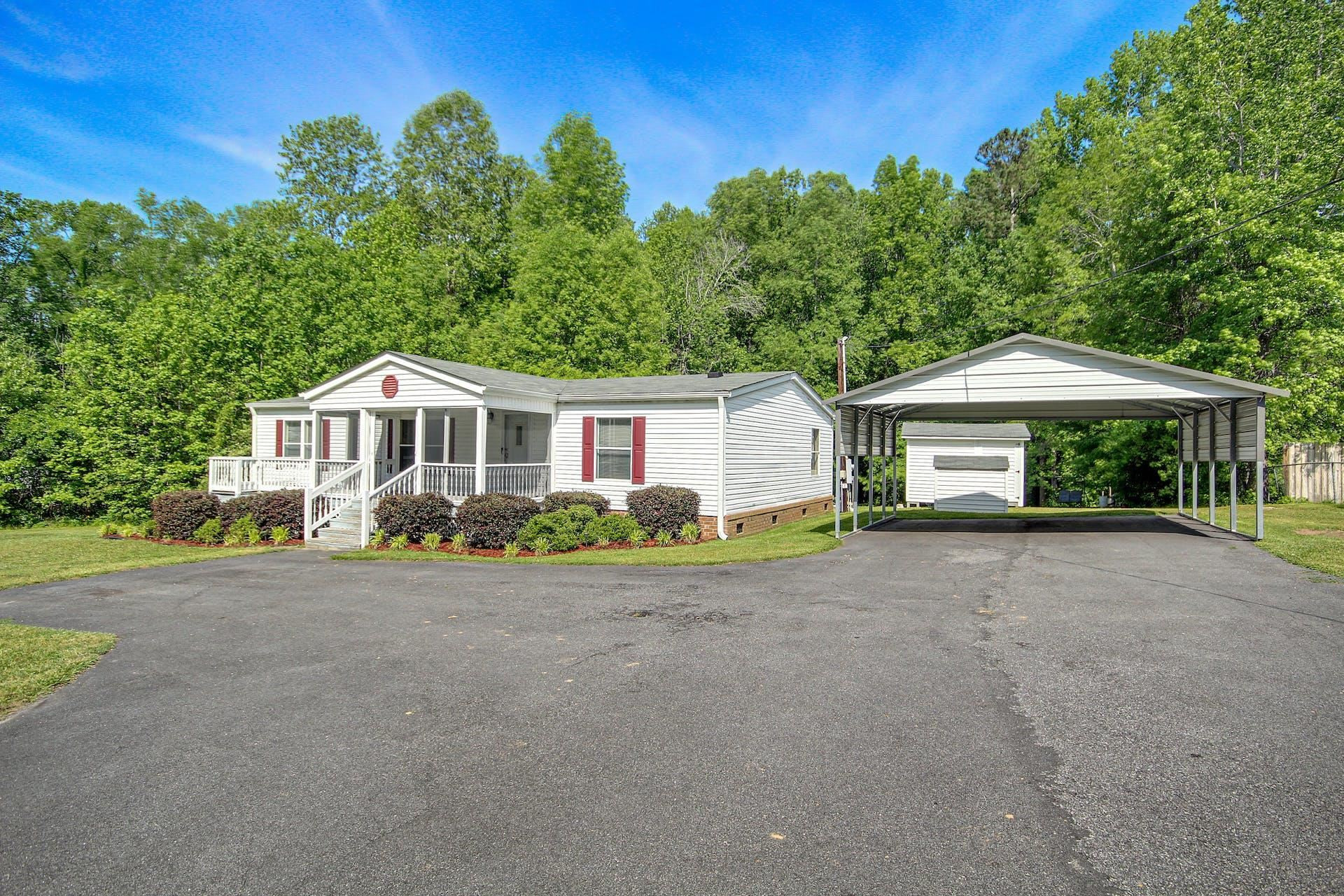 8144 Mt Pleasant Church Road Willow Spring, NC 27592 - Photo 2 of 25 a front view of a house with a garden