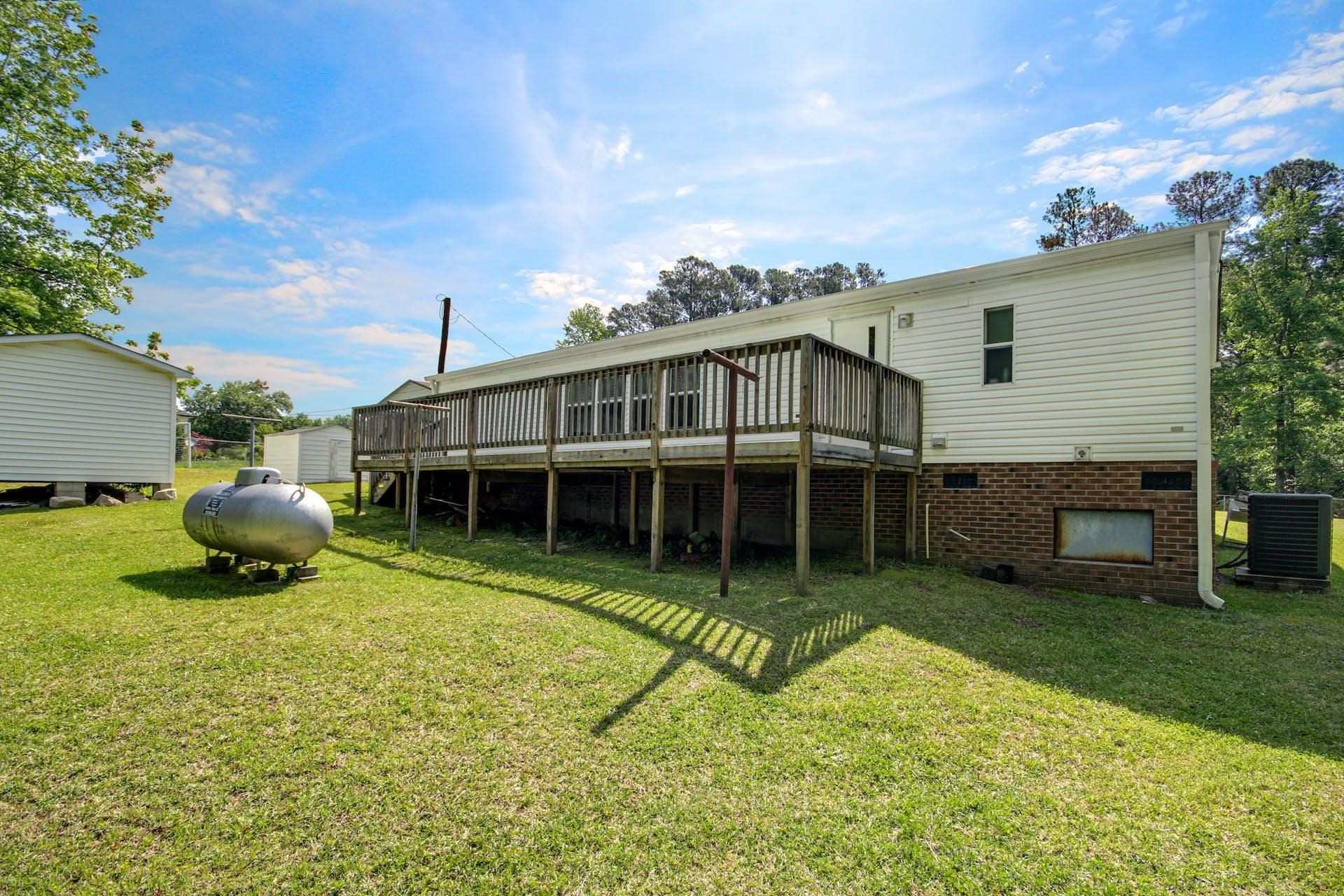 8144 Mt Pleasant Church Road Willow Spring, NC 27592 - Photo 22 of 25 a view of a house with a backyard and a patio