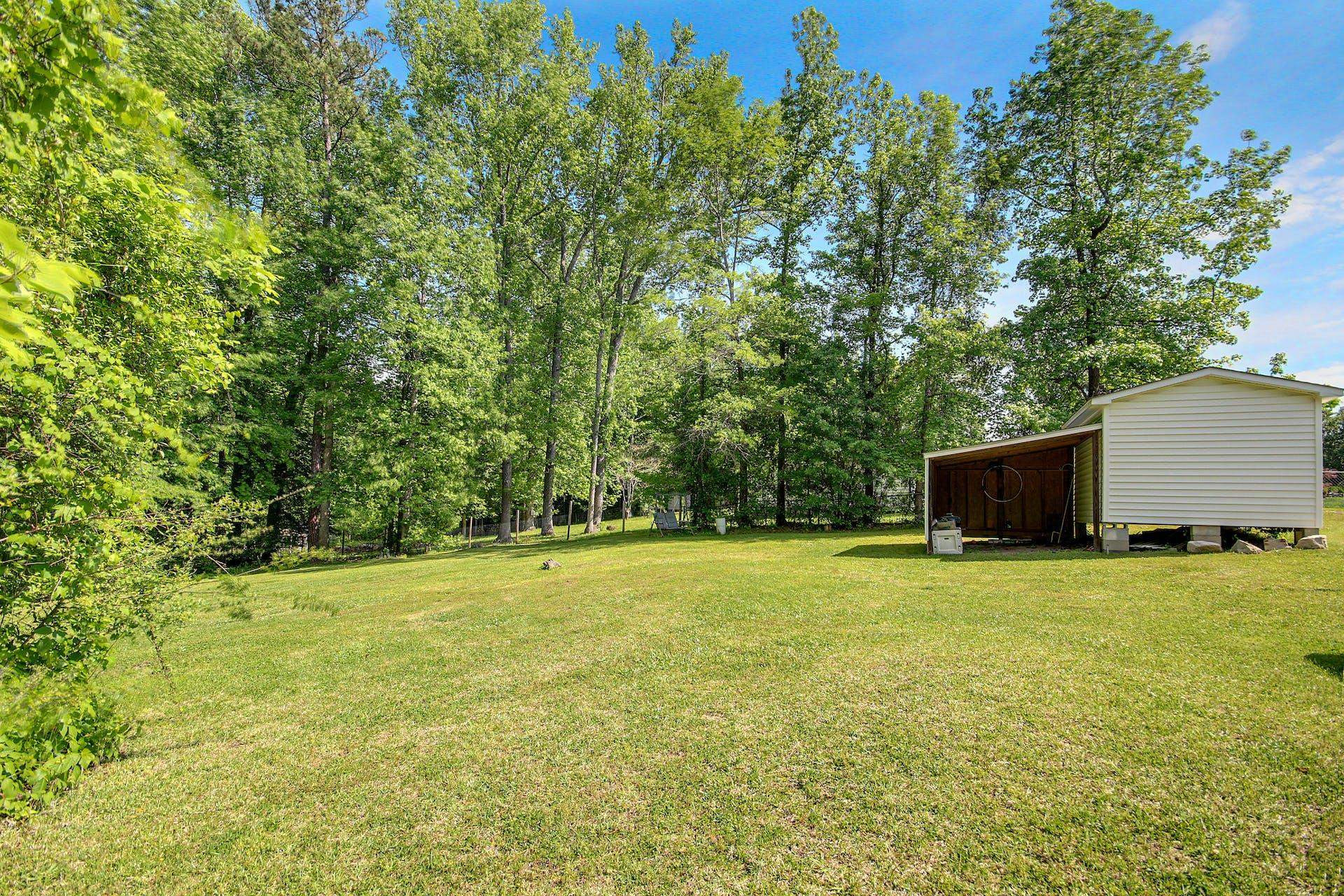 8144 Mt Pleasant Church Road Willow Spring, NC 27592 - Photo 23 of 25 a view of a big yard with large trees