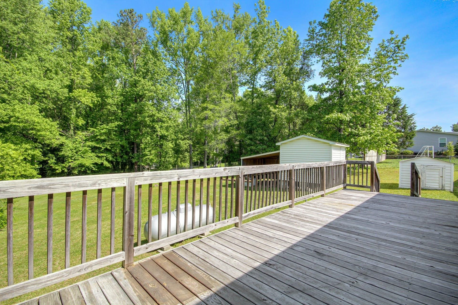 8144 Mt Pleasant Church Road Willow Spring, NC 27592 - Photo 24 of 25 a view of a balcony with wooden floor and fence